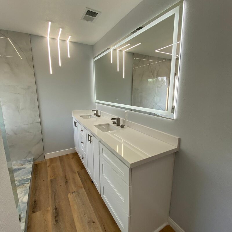 White vanity with wood floors